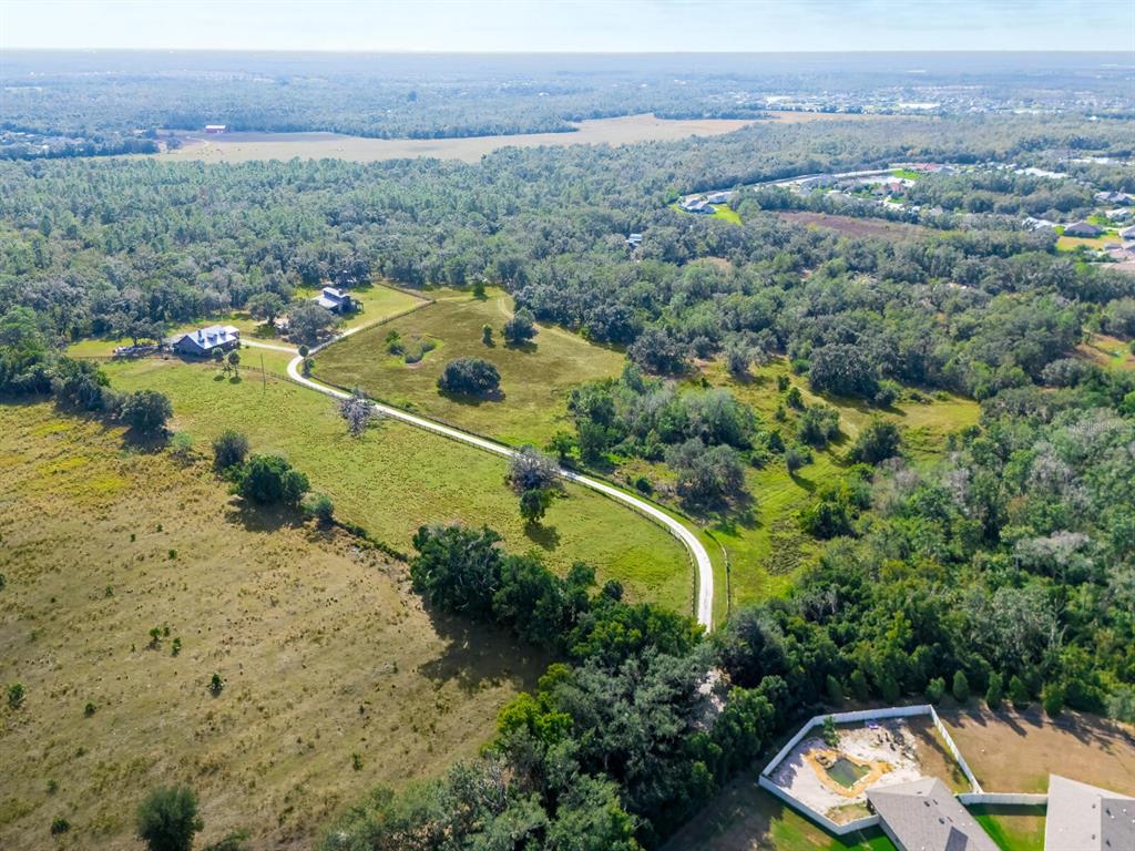 2405 North Rye Road Parrish, FL 34219 - Photo 3 of 5 an aerial view of a houses with a lake view