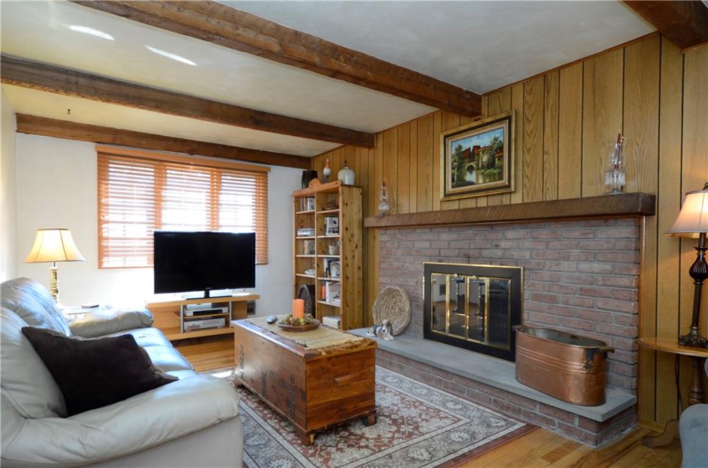 1033 Fiddleback Drive McKees Rocks, PA 15136 - Photo 10 of 20 The cozy family room showcases the hardwood flooring and a cozy fireplace.