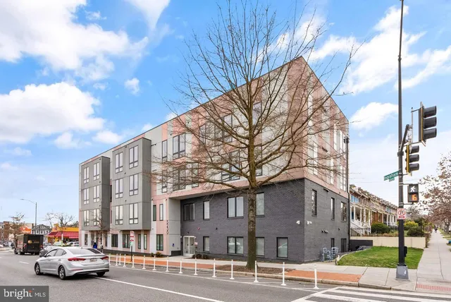 a city street lined with buildings and cars