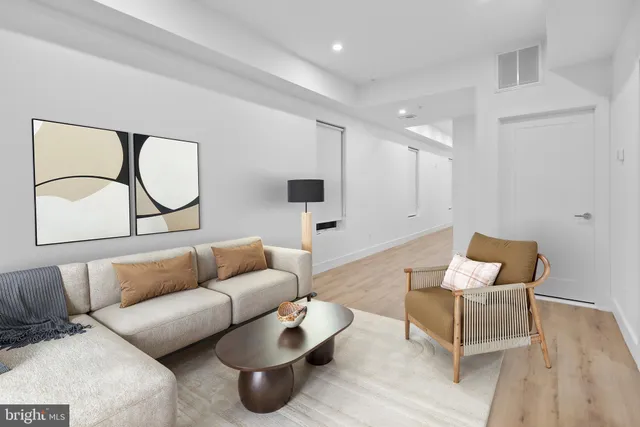 a living room with furniture and a wooden floor