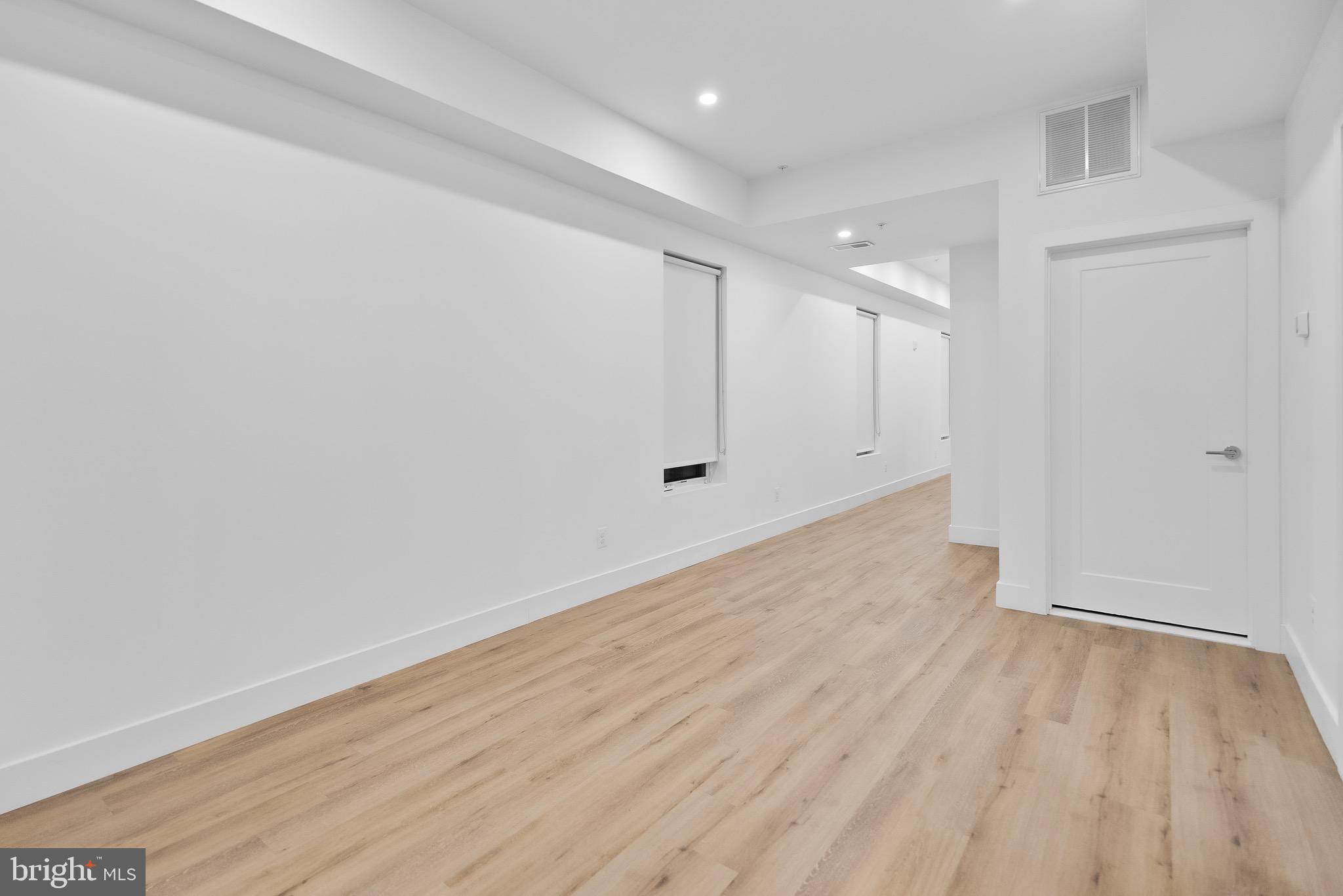 5230 Georgia Avenue Northwest, Unit 307 Washington, DC 20011 - Photo 5 of 15 wooden floor in an empty room