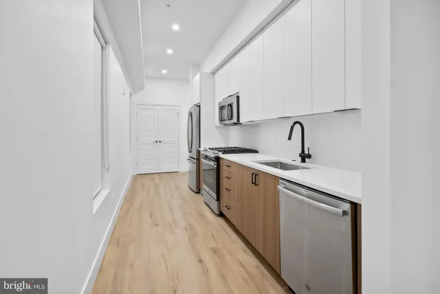 a kitchen with a sink and refrigerator
