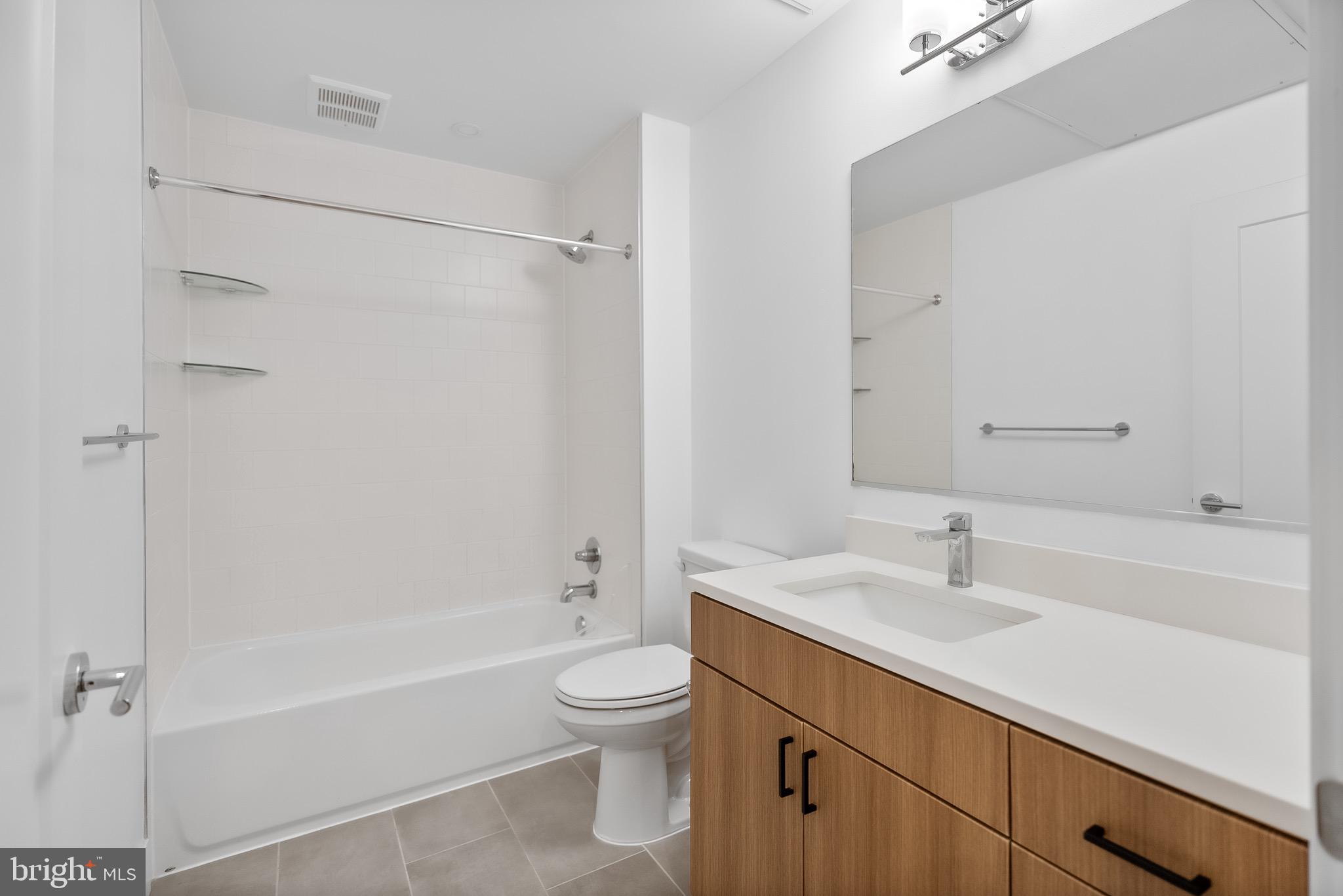 5230 Georgia Avenue Northwest, Unit 307 Washington, DC 20011 - Photo 10 of 15 a bathroom with a sink toilet and shower