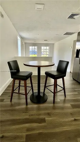 a view of a dining room with furniture and window