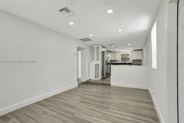 a view of kitchen and wooden floor