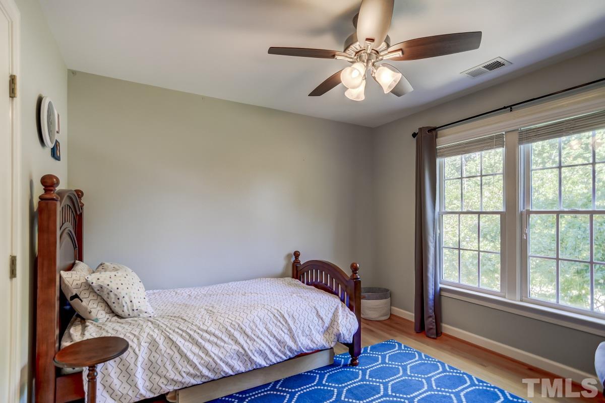 7934 Pine Timber Drive Raleigh, NC 27613 - Photo 15 of 22 a bedroom with a bed and a chandelier
