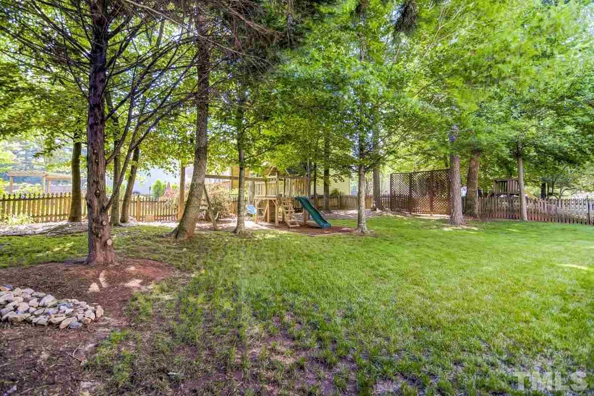 7934 Pine Timber Drive Raleigh, NC 27613 - Photo 21 of 22 a view of a yard with a tree