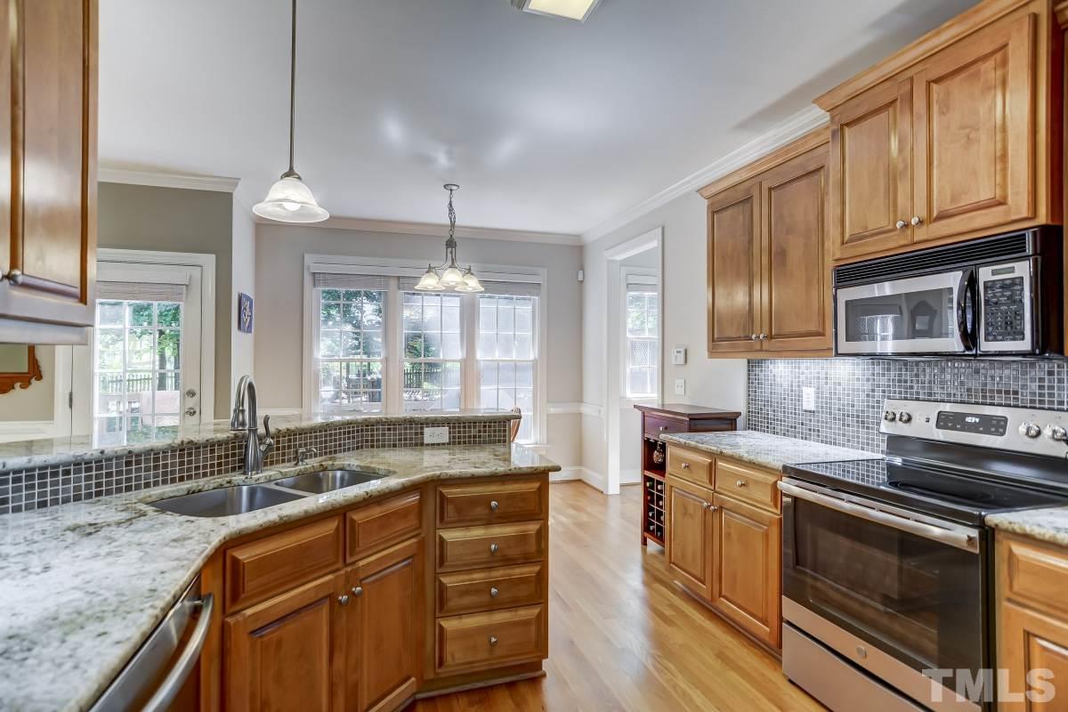 7934 Pine Timber Drive Raleigh, NC 27613 - Photo 8 of 22 a kitchen with stainless steel appliances granite countertop a sink stove and cabinets