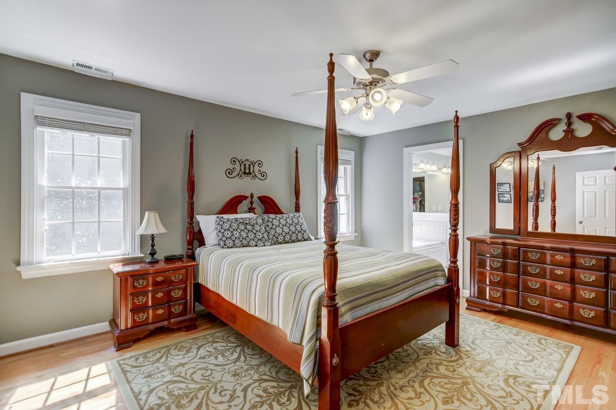 7934 Pine Timber Drive Raleigh, NC 27613 - Photo 10 of 22 a bedroom with a bed and wooden floor
