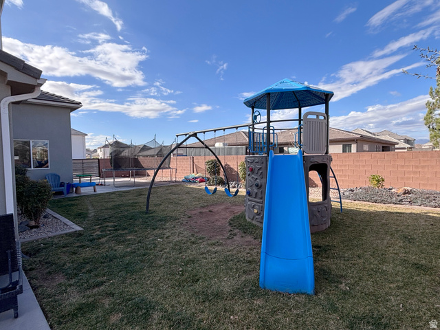429 East Treasure Road Washington, UT 84780 - Photo 29 of 36 View of jungle gym with a trampoline, a fenced backyard, a patio, and a residential view
