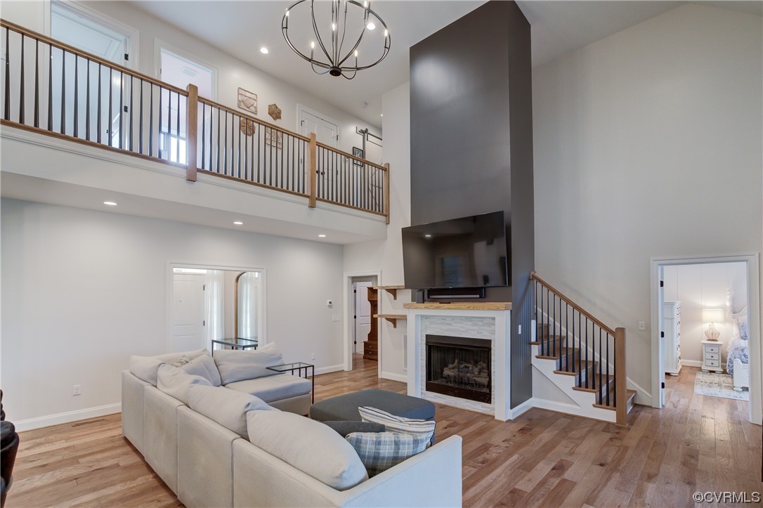 7097 Ware House Road Gloucester, VA 23061 - Photo 3 of 49 a living room with furniture a fireplace and a flat screen tv