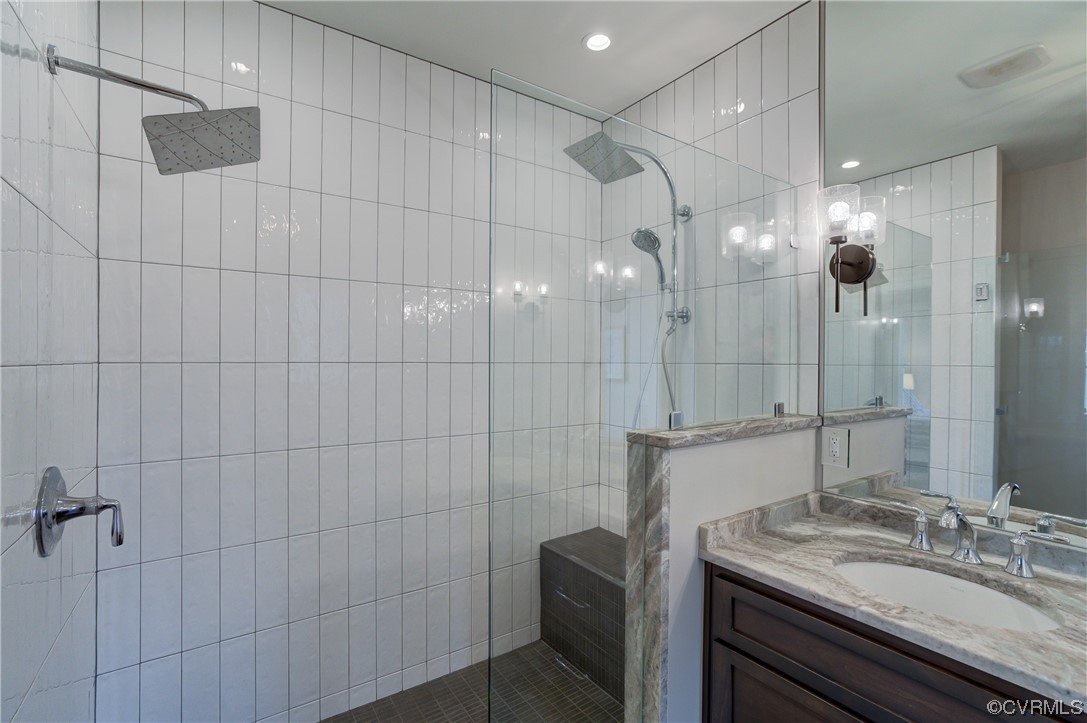 7097 Ware House Road Gloucester, VA 23061 - Photo 36 of 49 a bathroom with a granite countertop sink a toilet and shower