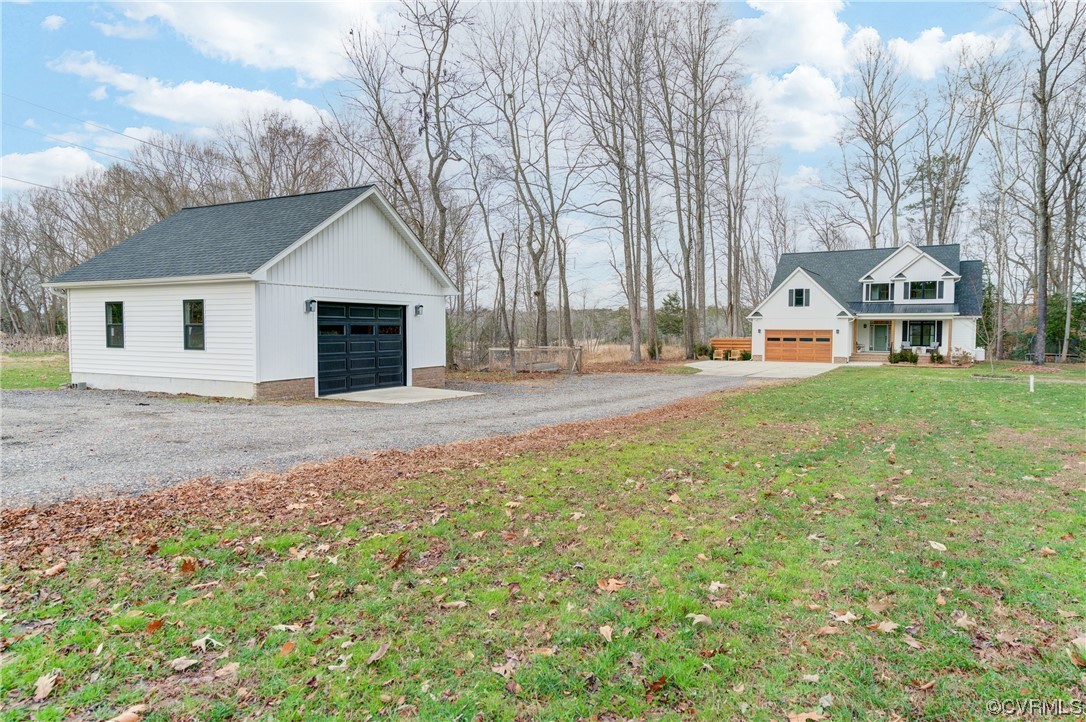 7097 Ware House Road Gloucester, VA 23061 - Photo 39 of 49 a front view of a house with a yard and garage