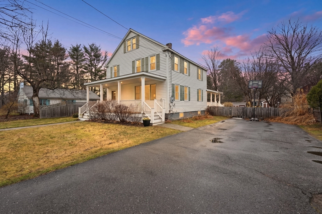 a front view of a house with a yard covered with snow