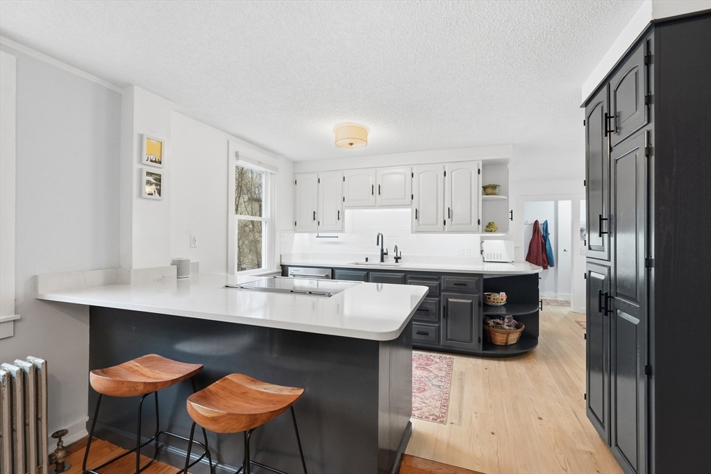 38 Front Street Northampton, MA 01053 - Photo 14 of 42 a kitchen with stainless steel appliances granite countertop a sink and a refrigerator
