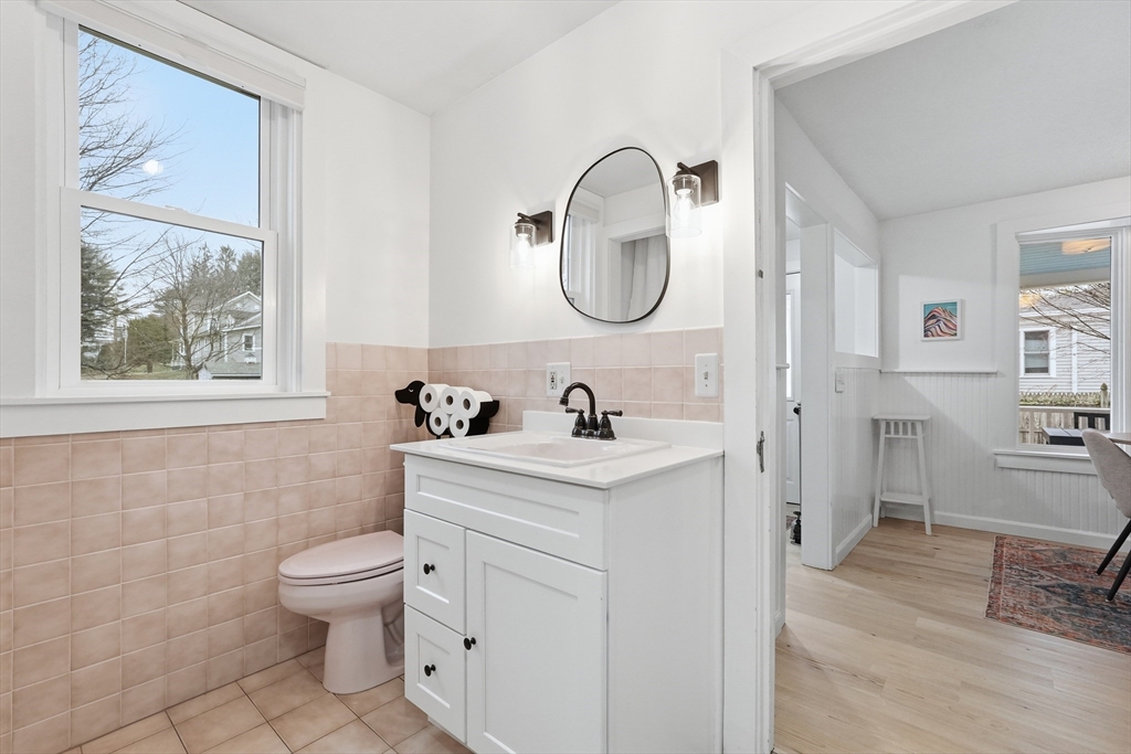 38 Front Street Northampton, MA 01053 - Photo 21 of 42 a bathroom with a toilet a sink a mirror and a window