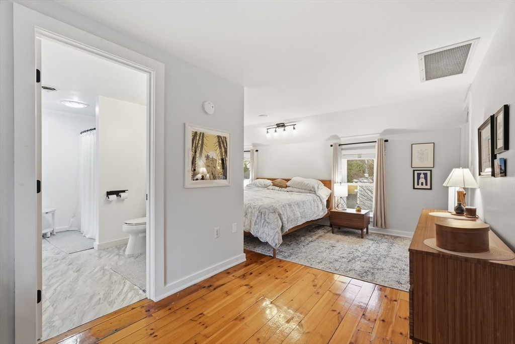 38 Front Street Northampton, MA 01053 - Photo 27 of 42 a bedroom with a bed and wooden floor