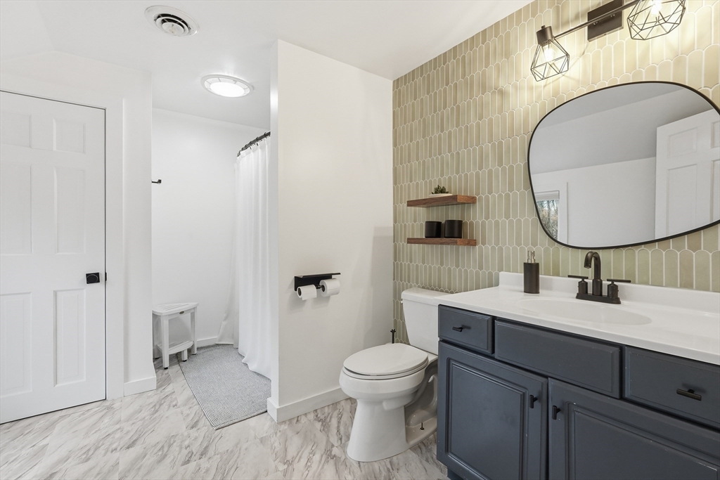 38 Front Street Northampton, MA 01053 - Photo 28 of 42 a bathroom with a toilet a sink and mirror