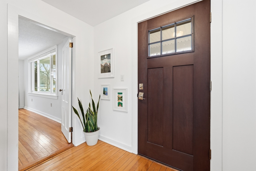 38 Front Street Northampton, MA 01053 - Photo 4 of 42 a view of a hallway with wooden floor and a potted plant