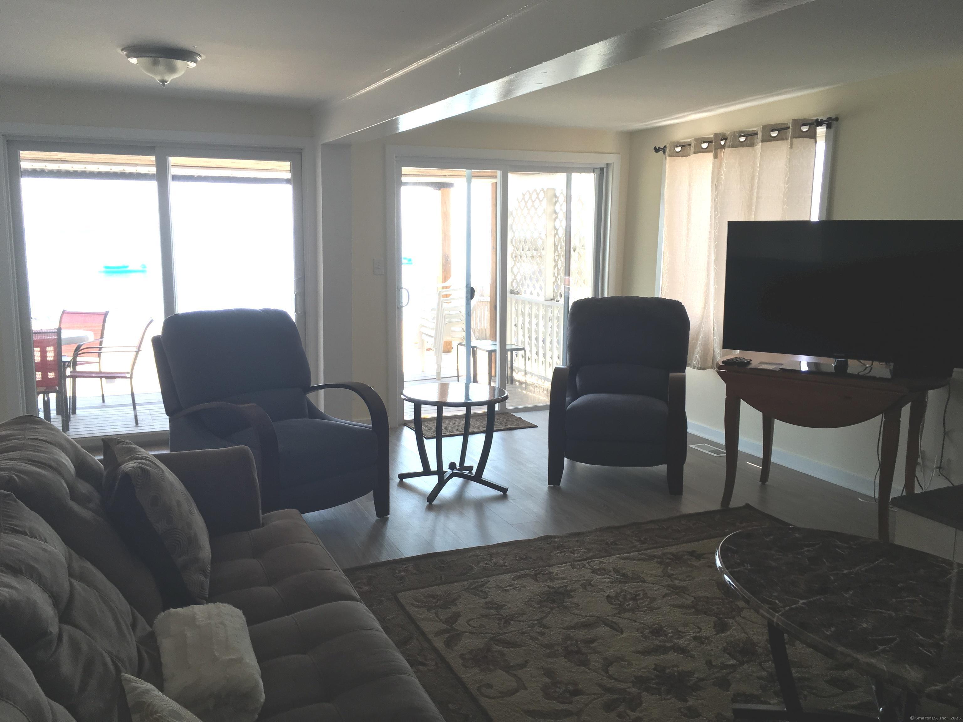 989 Fairfield Beach Road Fairfield, CT 06824 - Photo 14 of 27 a living room with furniture and a flat screen tv