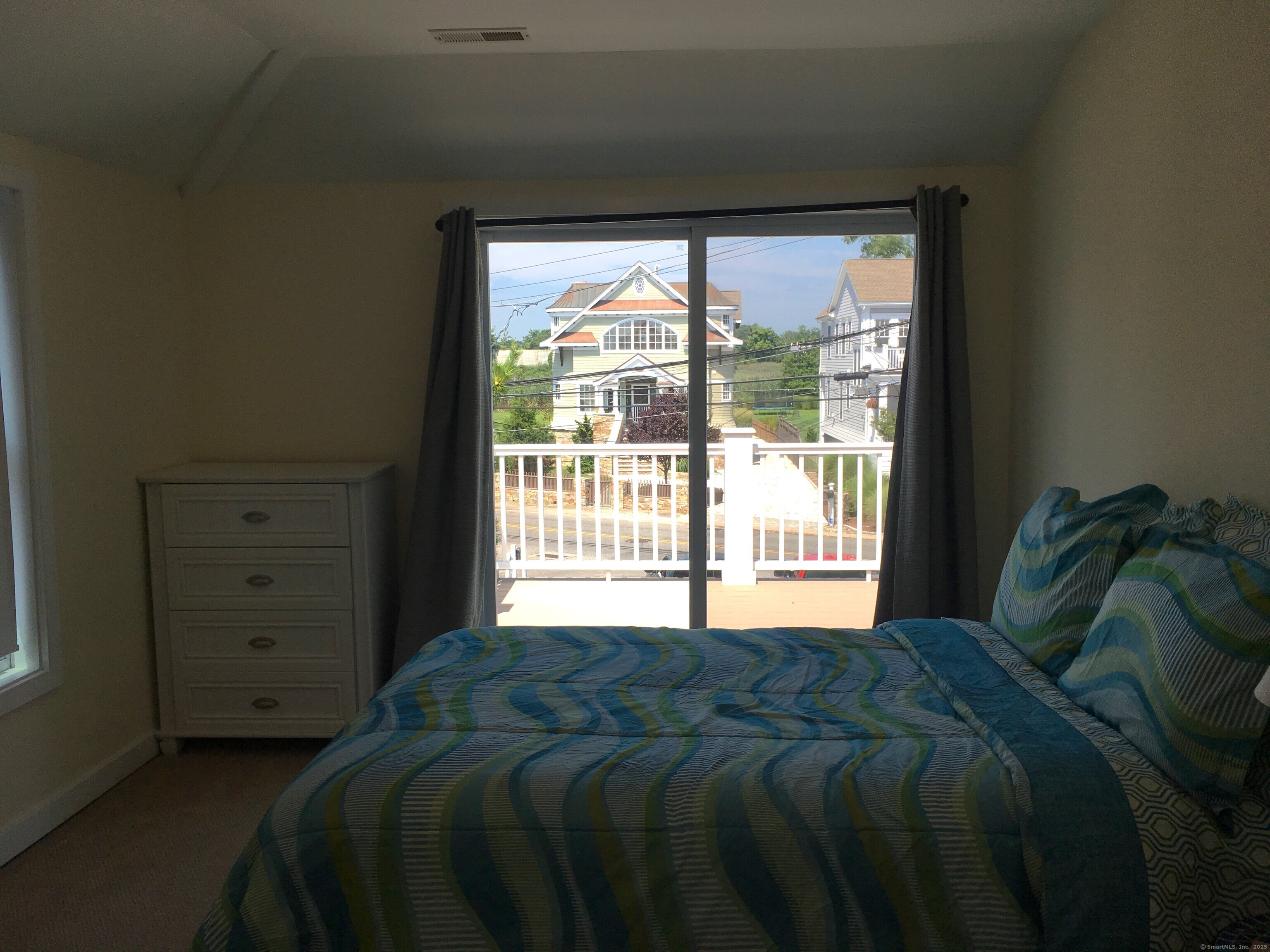 989 Fairfield Beach Road Fairfield, CT 06824 - Photo 16 of 27 a bed sitting in a bedroom next to a window