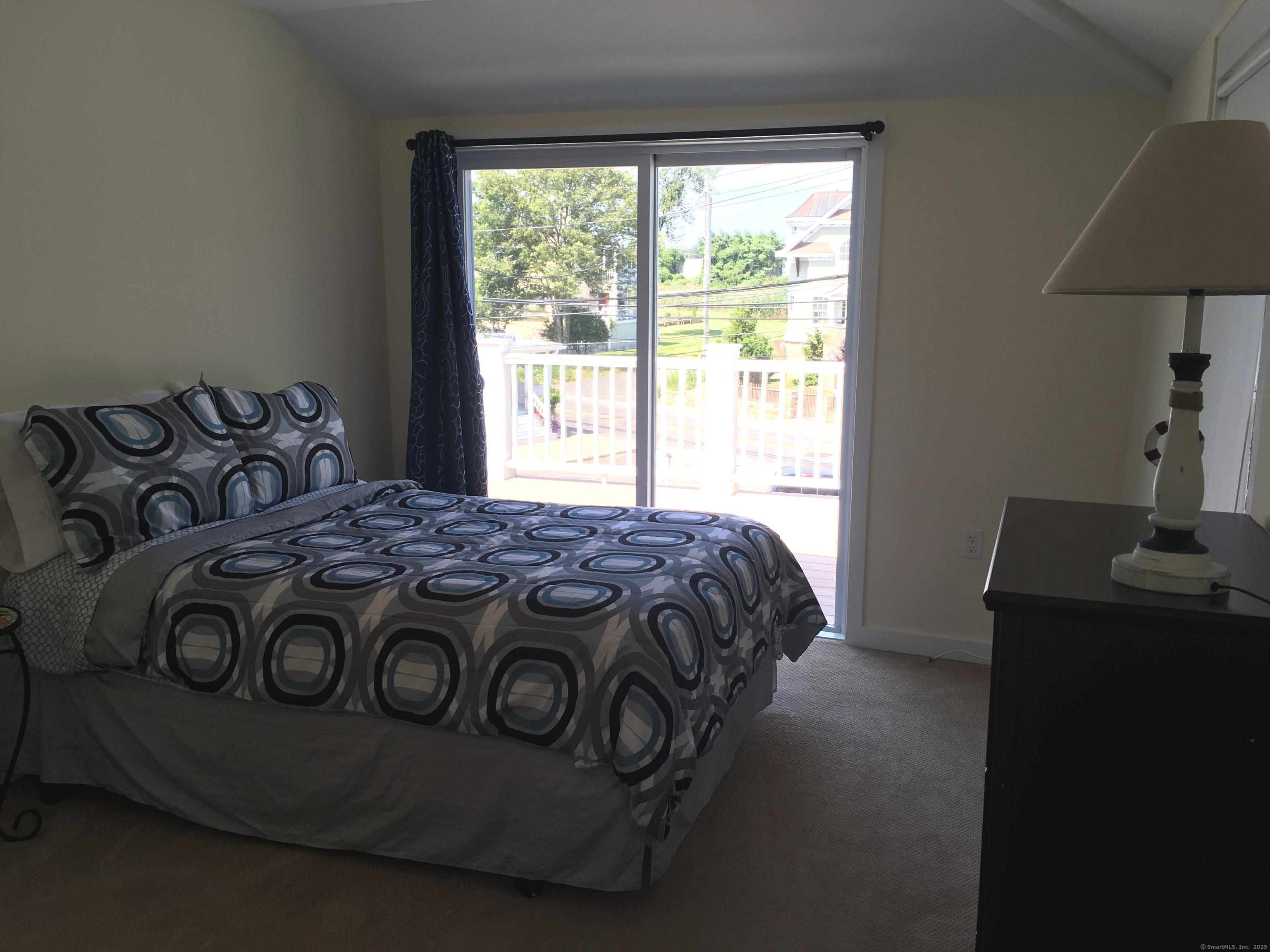 989 Fairfield Beach Road Fairfield, CT 06824 - Photo 18 of 27 a bedroom with a bed and a window