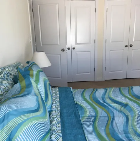 a room with a bed and a flat screen tv