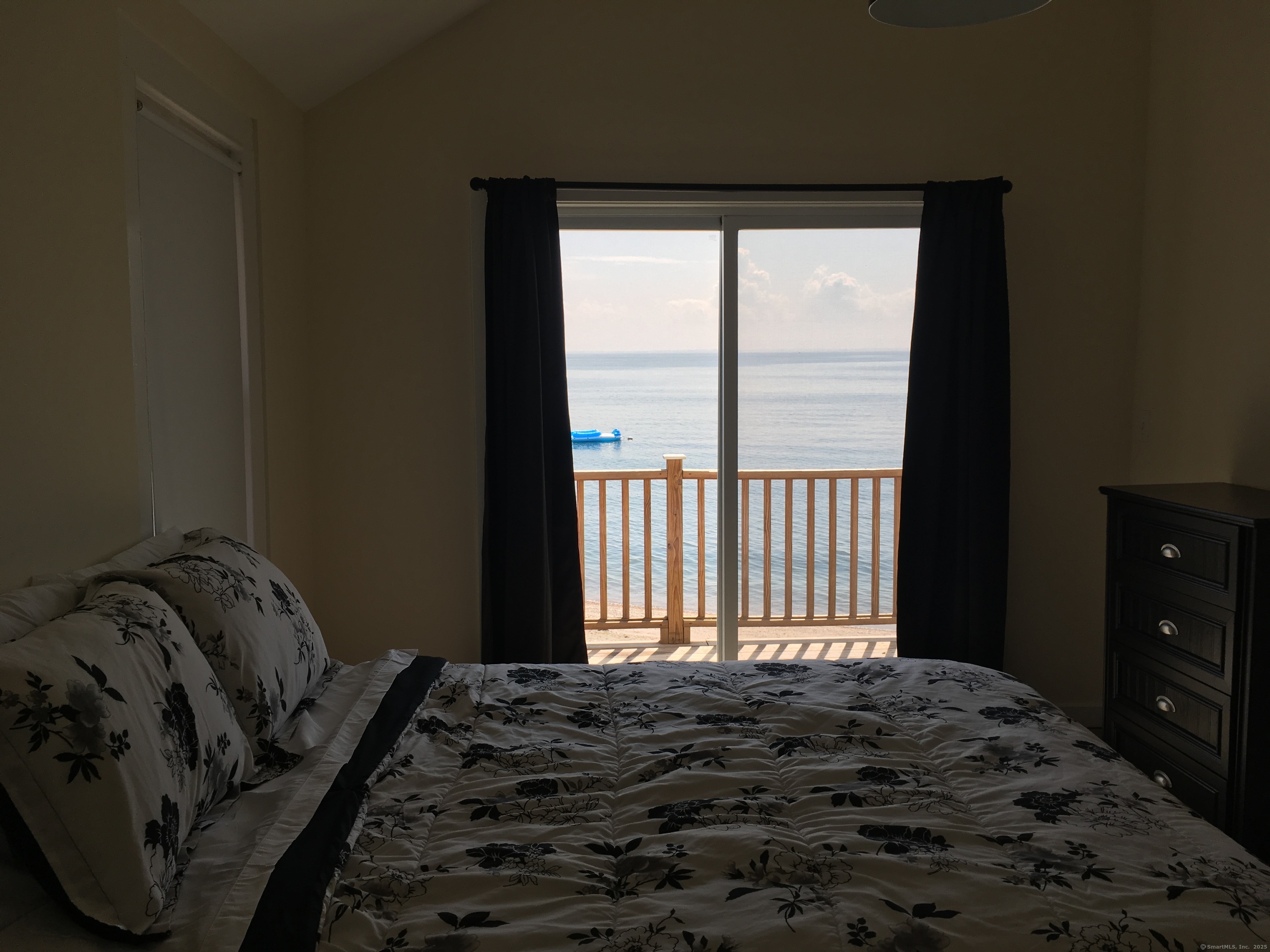 989 Fairfield Beach Road Fairfield, CT 06824 - Photo 20 of 27 a bedroom with a bed and a window