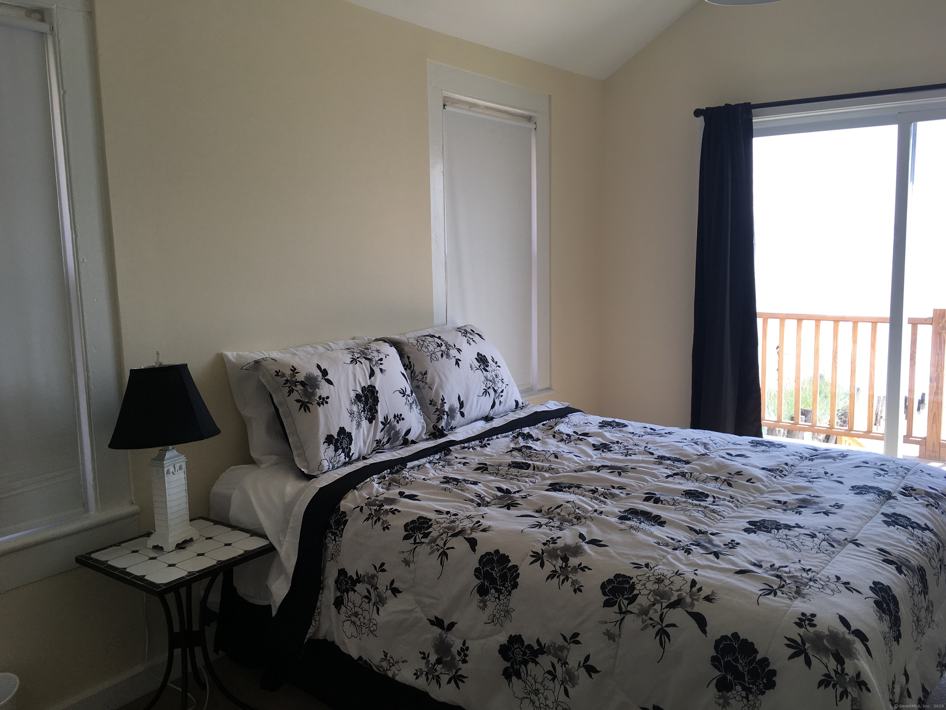 989 Fairfield Beach Road Fairfield, CT 06824 - Photo 21 of 27 a bedroom with a bed and wooden floor