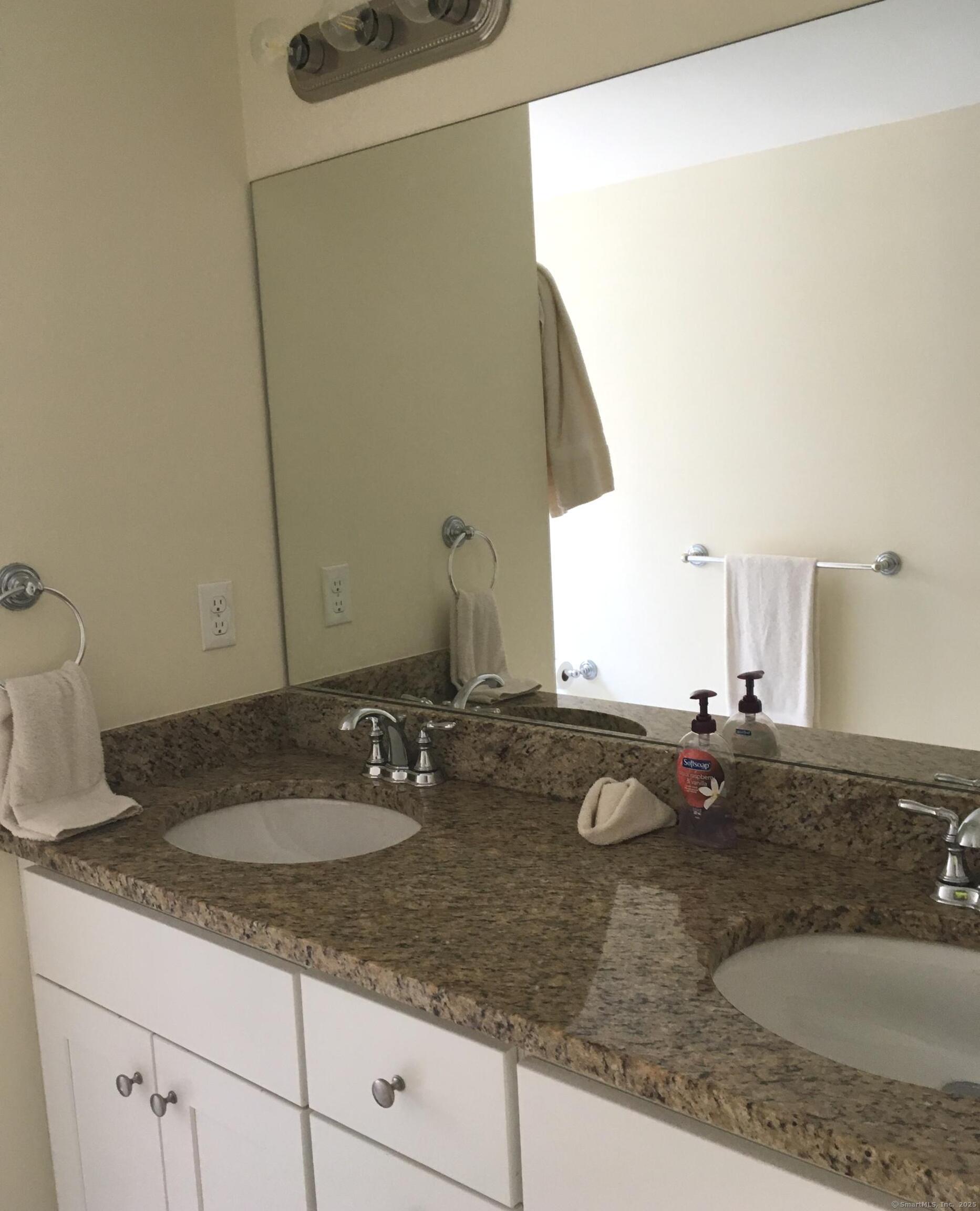 989 Fairfield Beach Road Fairfield, CT 06824 - Photo 23 of 27 a bathroom with a granite countertop sink and a mirror