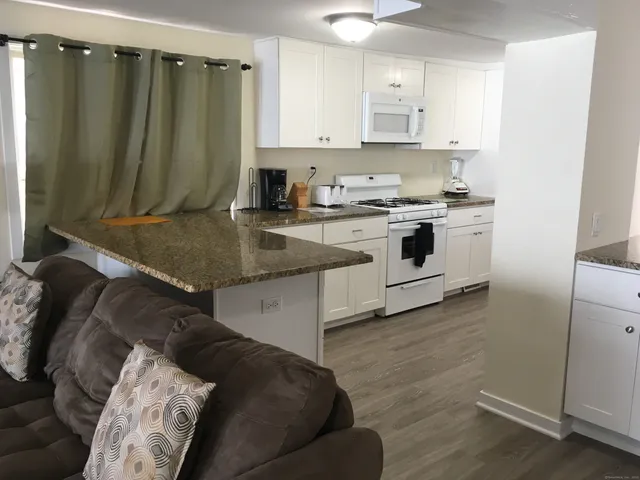 a kitchen with a stove a sink and a refrigerator