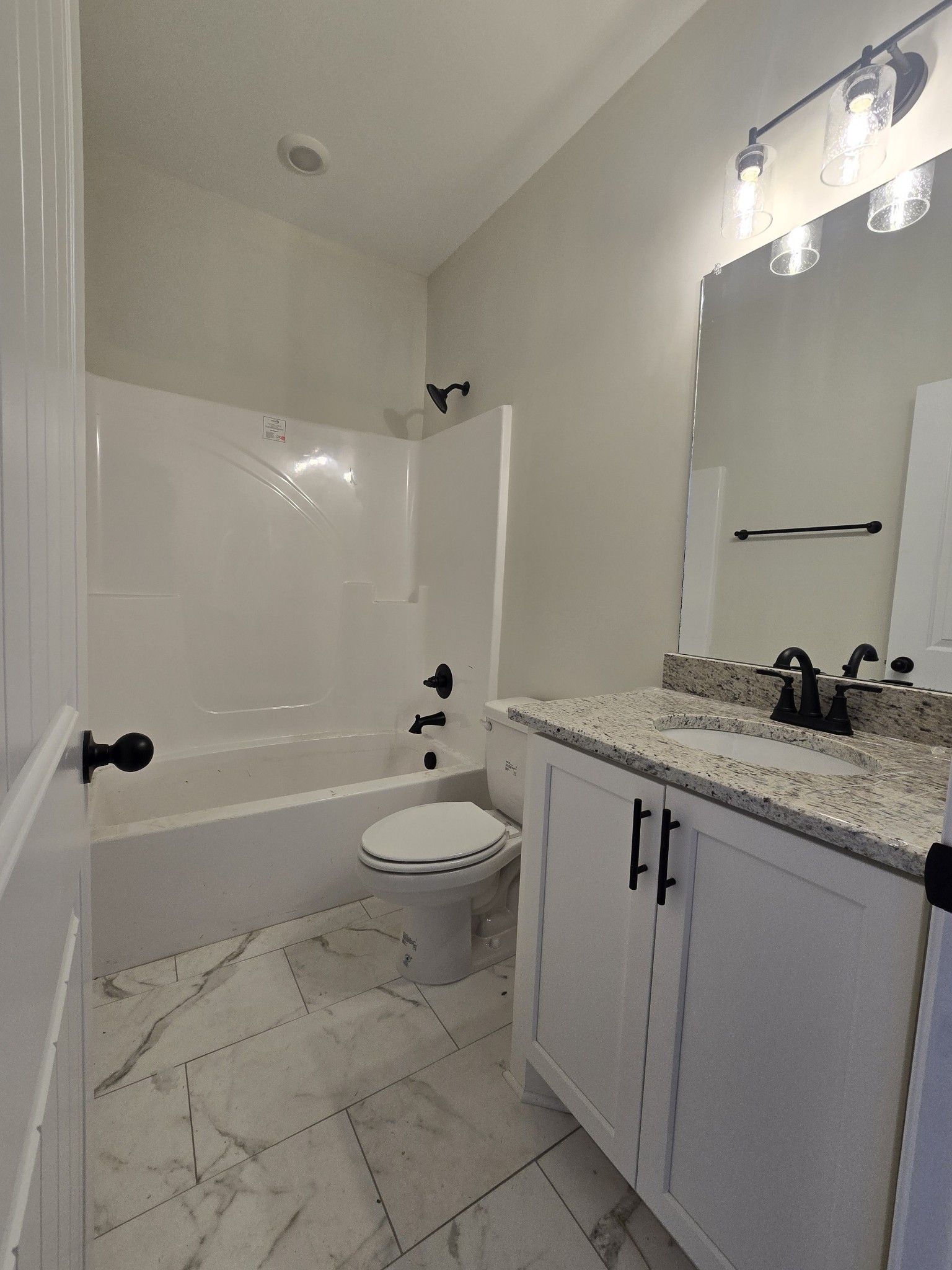 116 Dandelion Lane Beechgrove, TN 37018 - Photo 24 of 31 a bathroom with a granite countertop toilet a sink and a bathtub