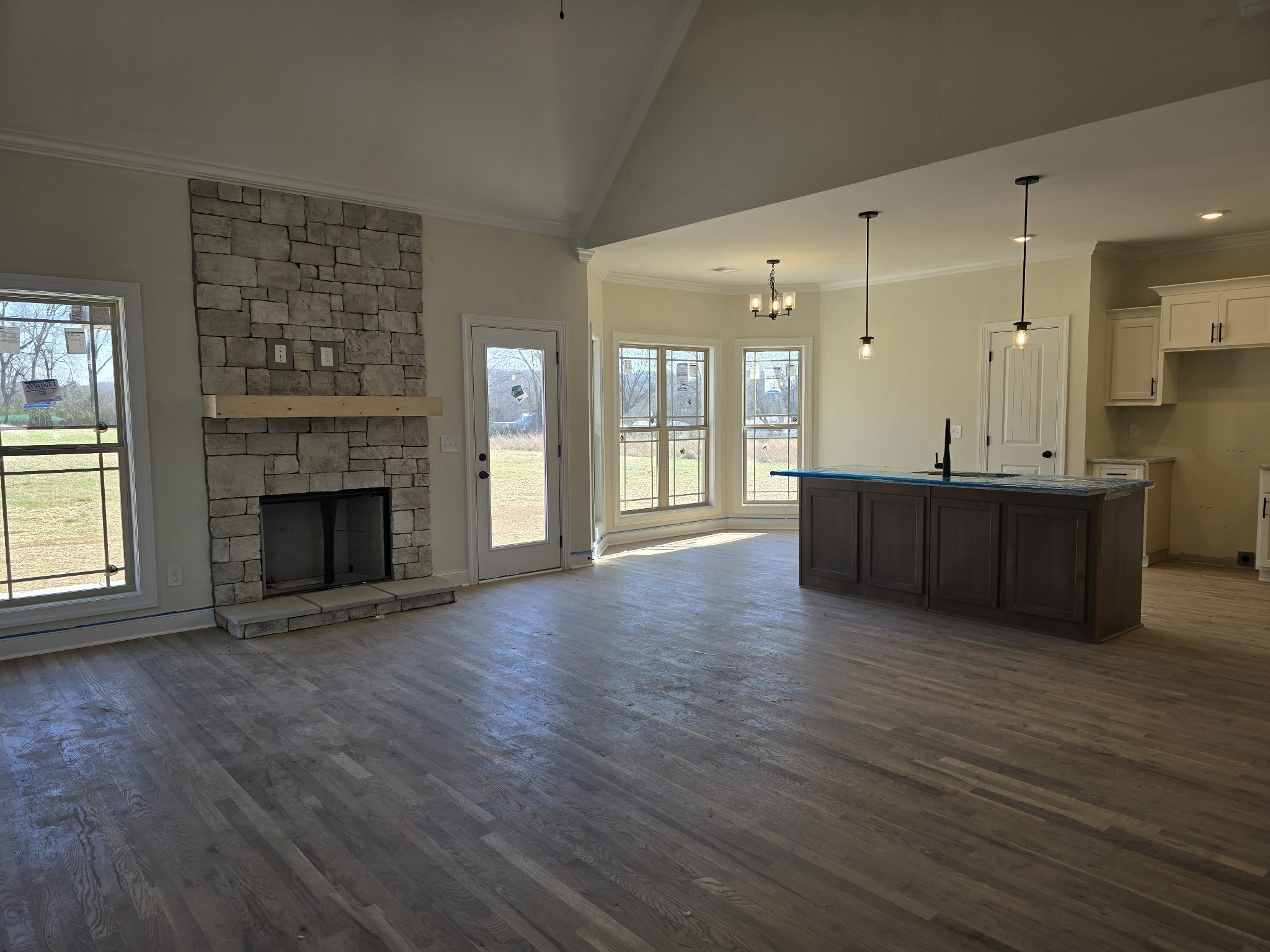 116 Dandelion Lane Beechgrove, TN 37018 - Photo 10 of 31 an empty room with wooden floor a fireplace and windows