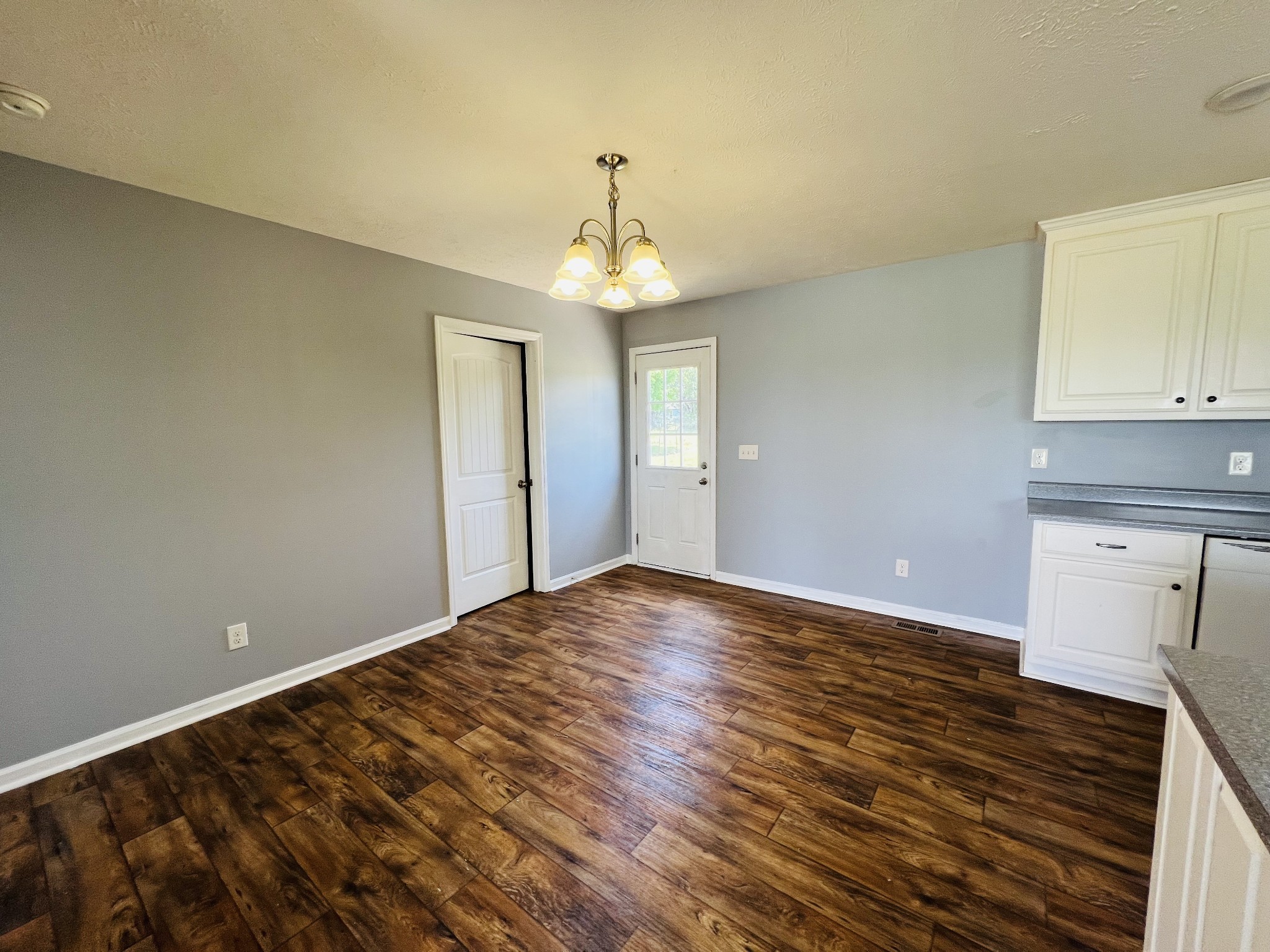 4560 Fall River Road Pulaski, TN 38478 - Photo 10 of 28 a view of an empty room with wooden floor and a window