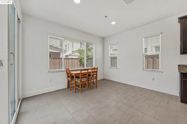 a view of a dining room with furniture and windows