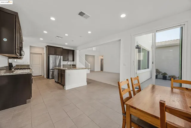 a large kitchen with a table and chairs in it