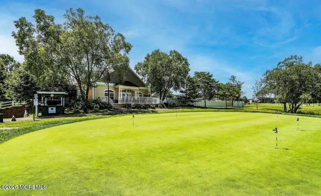 a view of a patio with table and chairs potted plants with the view of lake