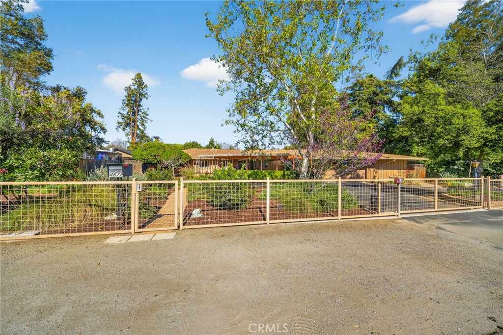 a view of a tennis court with a fence