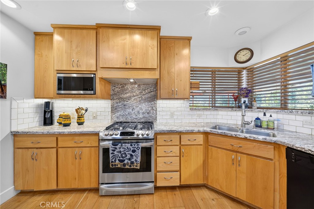 4872 N Arcade Fresno, CA 93704 - Photo 12 of 75 a kitchen with stainless steel appliances a stove sink and cabinets