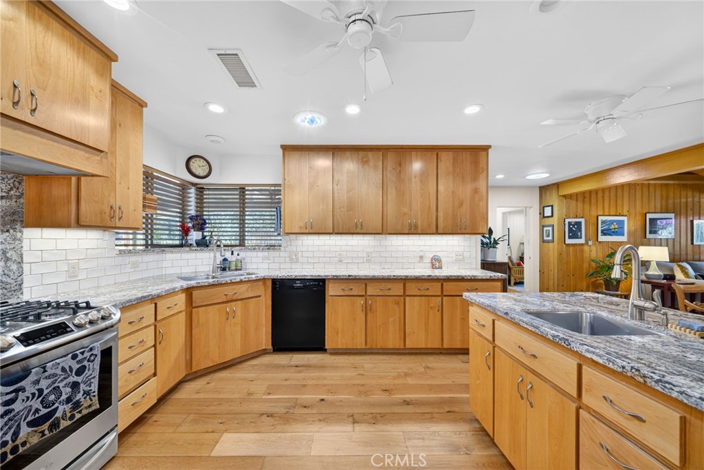 4872 N Arcade Fresno, CA 93704 - Photo 13 of 75 a large kitchen with stainless steel appliances granite countertop a sink stove and refrigerator
