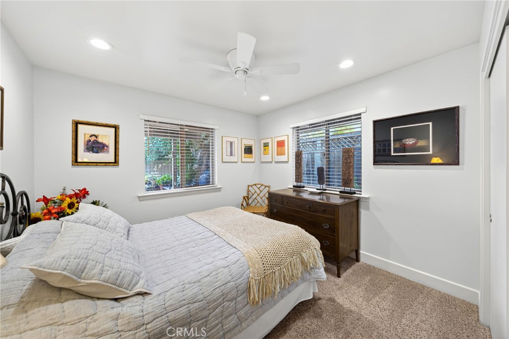 4872 N Arcade Fresno, CA 93704 - Photo 29 of 75 a bedroom with a bed and dresser with mirror