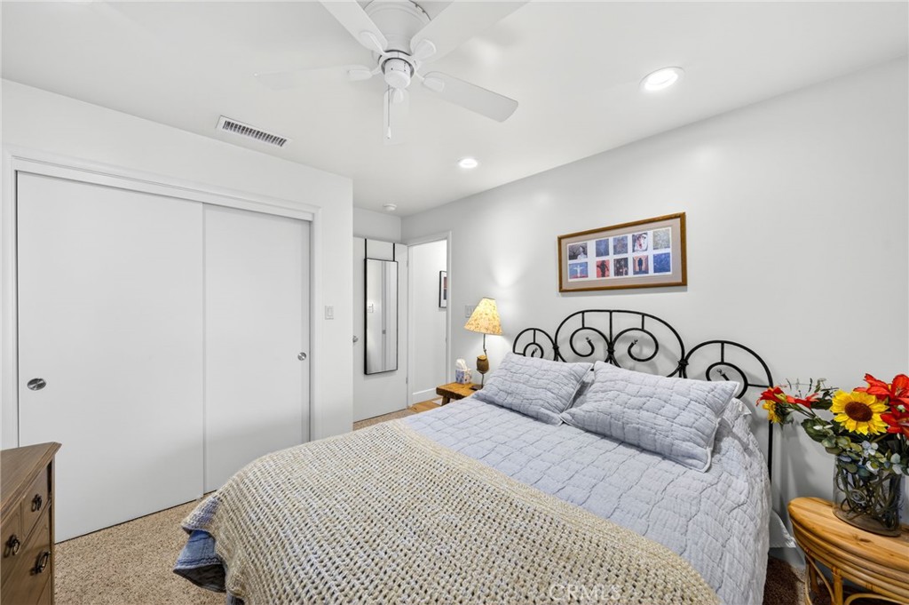 4872 N Arcade Fresno, CA 93704 - Photo 30 of 75 a bedroom with a bed and a chandelier