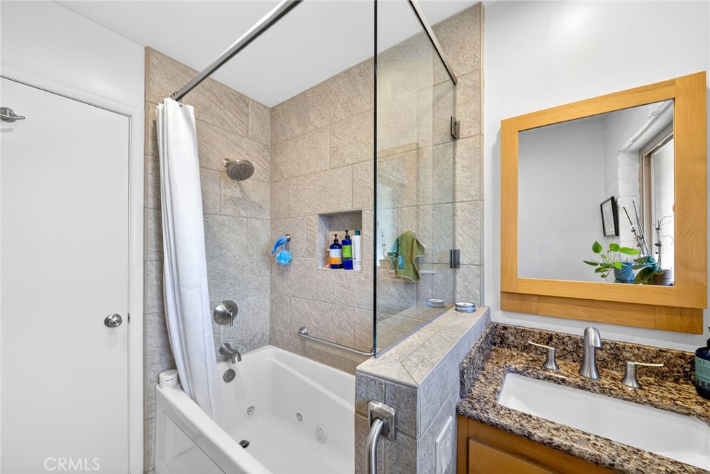 4872 N Arcade Fresno, CA 93704 - Photo 35 of 75 a bathroom with a sink and a mirror