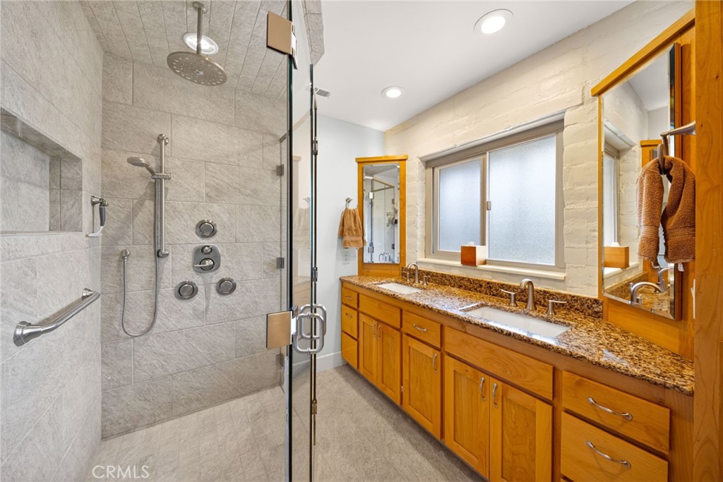 4872 N Arcade Fresno, CA 93704 - Photo 40 of 75 a bathroom with a granite countertop sink mirror and a shower