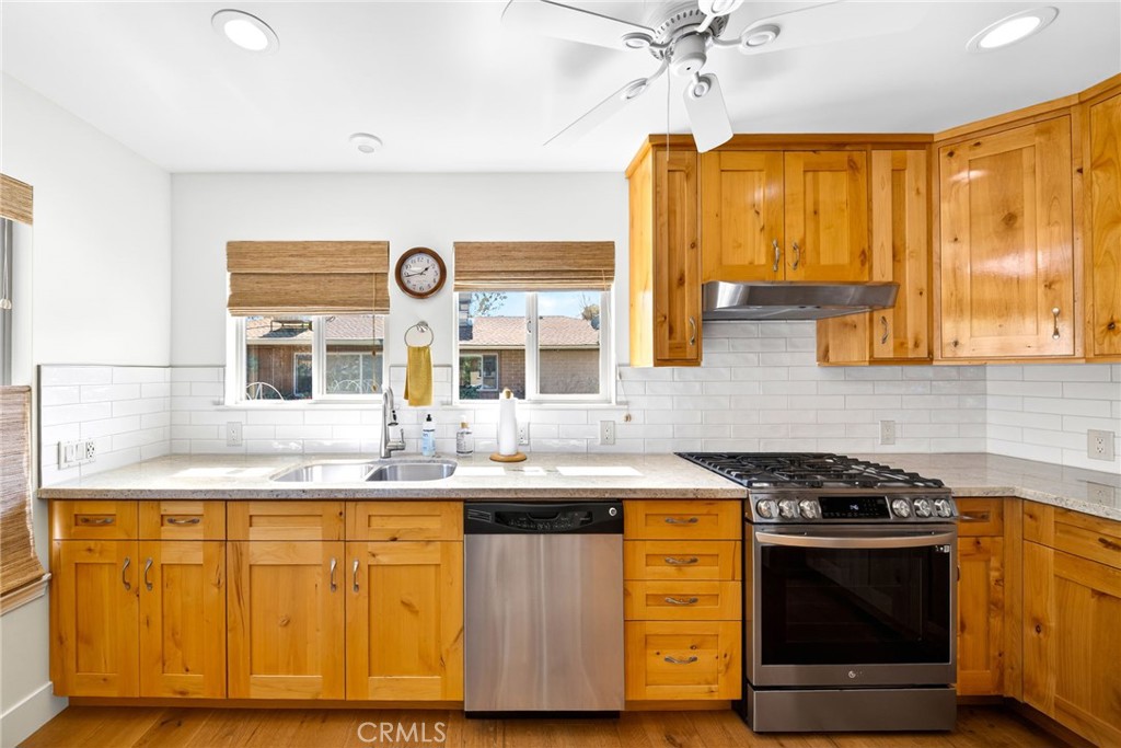 4872 N Arcade Fresno, CA 93704 - Photo 47 of 75 a kitchen with stainless steel appliances granite countertop a sink and a stove
