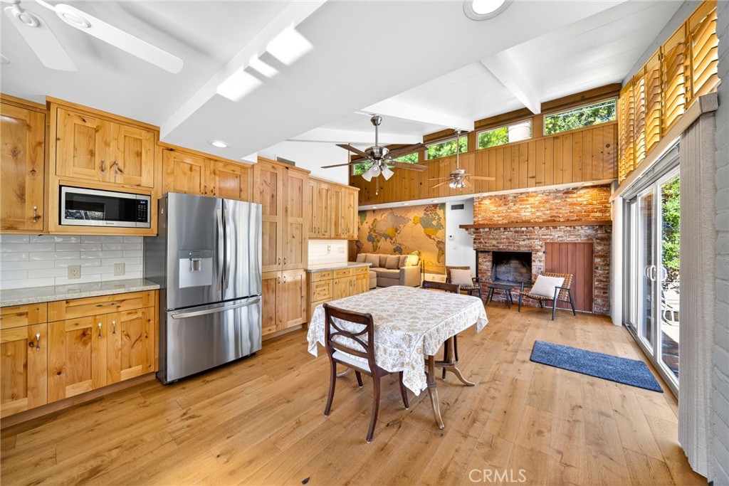 4872 N Arcade Fresno, CA 93704 - Photo 49 of 75 a kitchen with a table chairs refrigerator and microwave