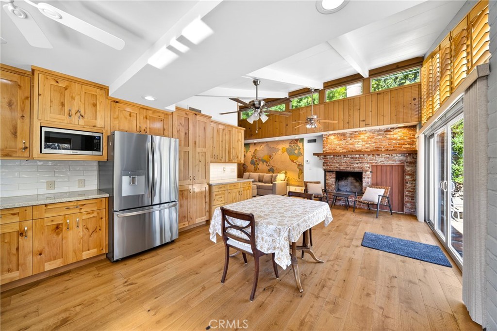 4872 N Arcade Fresno, CA 93704 - Photo 55 of 75 a kitchen with a table chairs refrigerator and microwave
