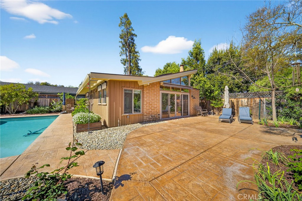 4872 N Arcade Fresno, CA 93704 - Photo 69 of 75 a front view of a house with a yard and potted plants