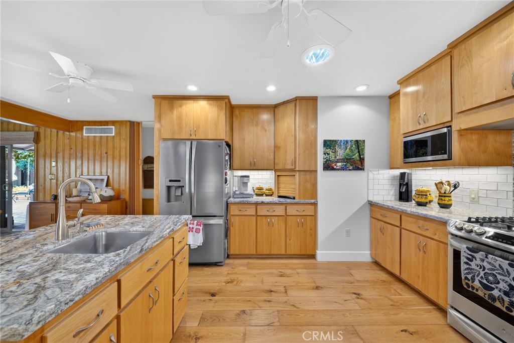 4872 N Arcade Fresno, CA 93704 - Photo 10 of 75 a kitchen with stainless steel appliances granite countertop a sink stove and refrigerator