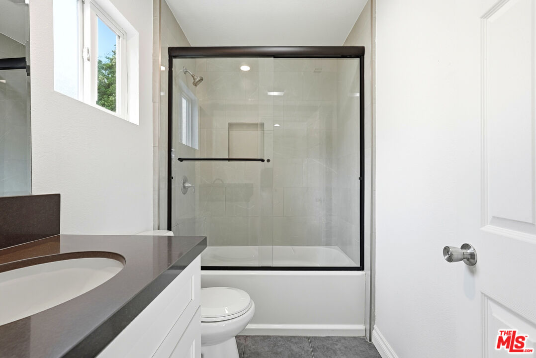 18149 Welby Way Reseda, CA 91335 - Photo 11 of 50 a bathroom with a toilet a sink and a bathtub